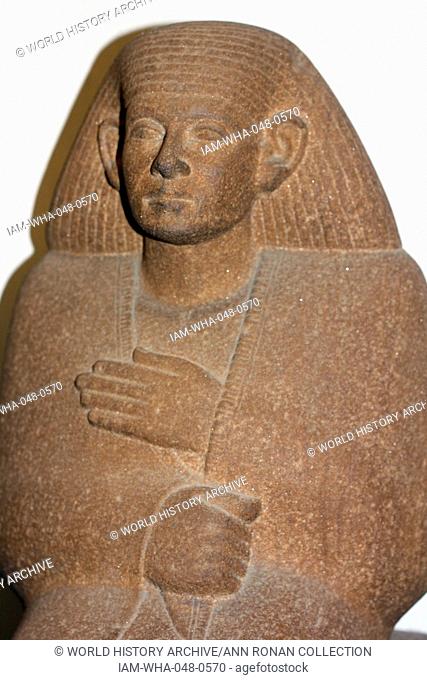 Quartzite statue of Ankhrekhu, 12th dynasty, about 1850 BC. The figure wears a long cloak from which only the hands emerge