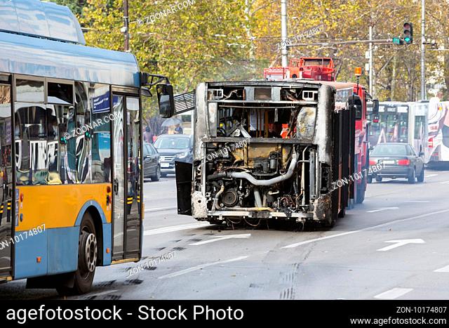 Sofia, Bulgaria - November 8, 2016: Burnt public traffic bus is seen on the street after caught in fire during travel and extinguished by firefighters
