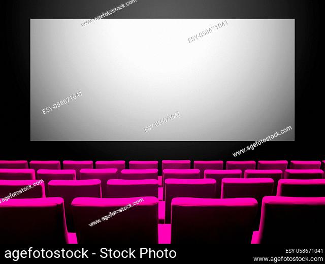 Cinema movie theatre with pink velvet seats and a blank white screen. Copy space background