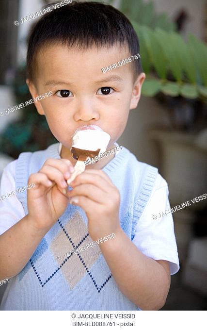 Chinese boy eating ice cream
