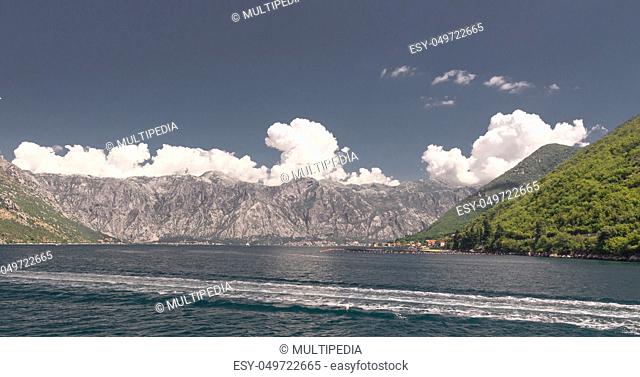 Panoramic view from the sea to the Kamenari-Lepetane Ferry crossing in the Bay of Kotor, Montenegro, in a sunny summer day