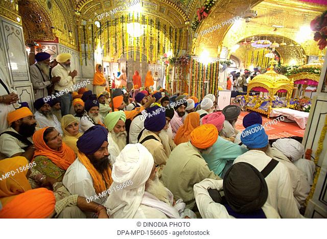 Celebrations of 300th year of consecration of perpetual Guru Granth Sahib Sikh ; devotees praying at Sachkhand Saheb Gurudwara in Nanded ; Maharashtra ; India