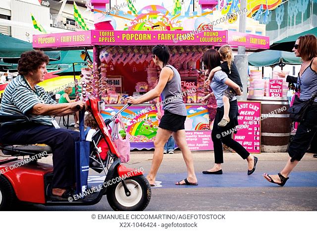 Visitors walking past the candies kiosk at the Easter Show, Sydney, Australia