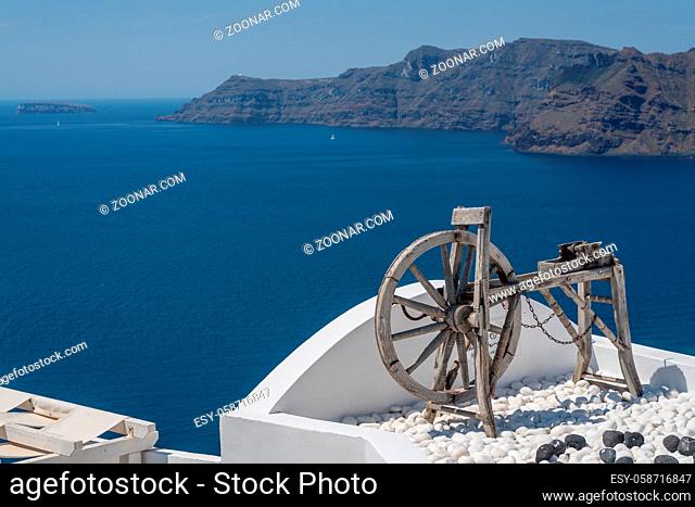 Old wooden spinning lathe above blue ocean in Santorini