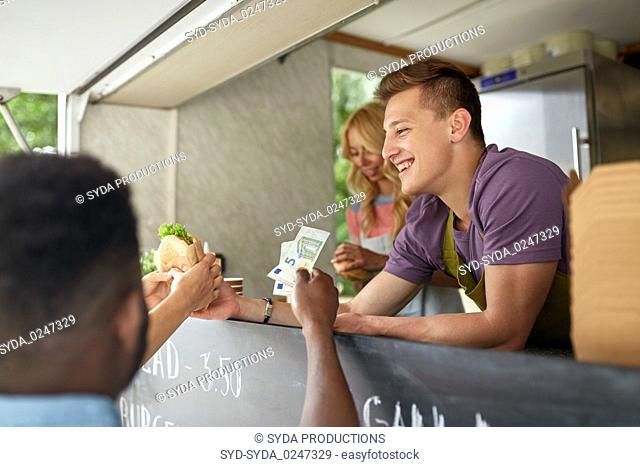 happy salesman selling hamburgers at food truck