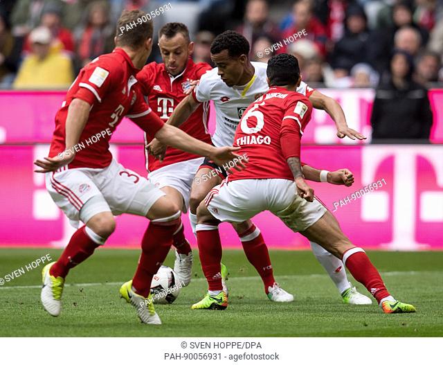 Joshua Kimmich (L-R), Rafinha and Thiago Alcantara of Munich and Robin Kwamina Quaison of Mainz vie for the ball during the German Bundesliga soccer match...