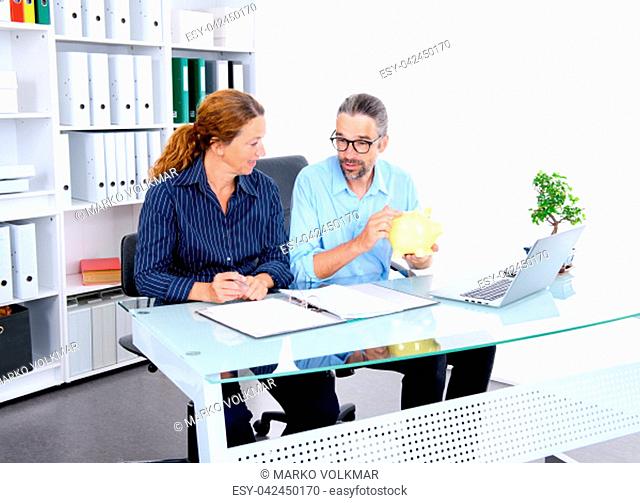 young businessman with piggy bank and businesswoman together in the office