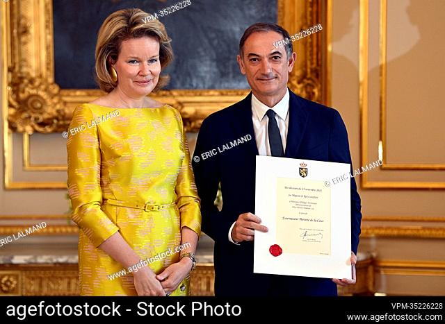 Queen Mathilde of Belgium and Philippe Fortunato of Delvaux Createur pictured during a royal reception with the newly appointed suppliers holding a 'Royal...
