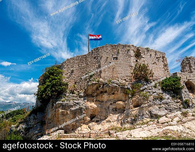 Croatian flag flies above ruins of old Venetian fort above the coastal town of Novigrad in Croatia