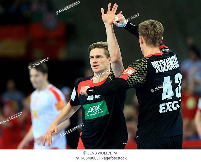 Germany's Rune Dahmke celebrates with Niclas Pieczkowski during the 2016 Men's European Championship handball group 2 match between Germany and Denmark at the...