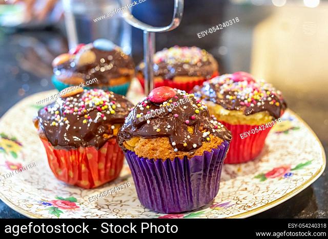 Chocolate covered cupcakes, with sprinkles on top