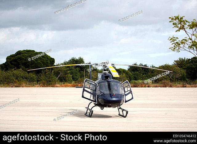 View of a small helicopter stationed on the ground