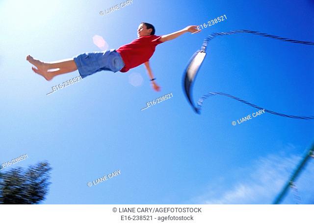 boy jumping from swing