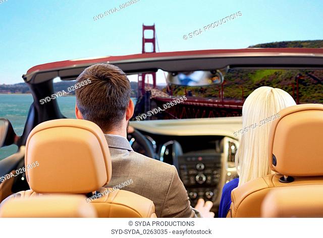 couple driving in car over golden gate bridge