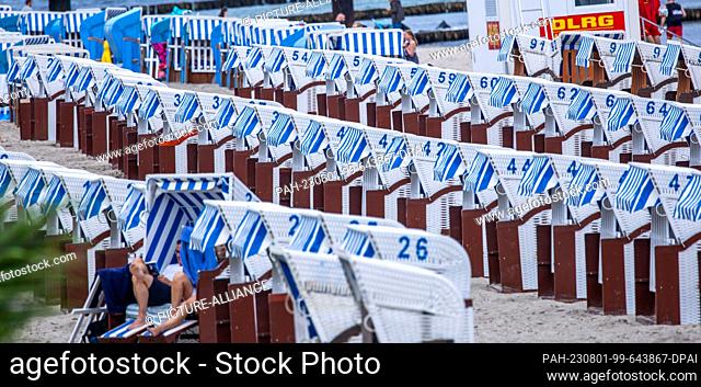 01 August 2023, Mecklenburg-Western Pomerania, Kühlungsborn: Most of the beach chairs on the Baltic coast are empty. The weather in northern Germany is...