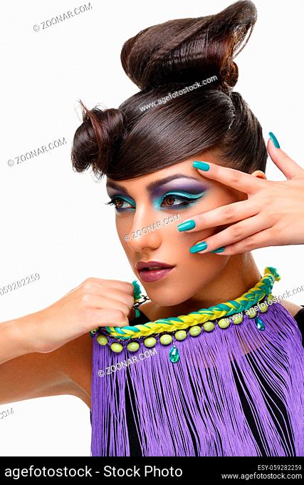 Beautiful young woman with bright purple make-up and fancy hairdo. Long green nails. Beauty shot isolated on white background. Copy space