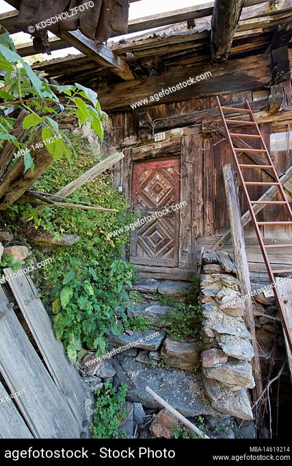 Front door of an abandoned mountain farm in South Tyrol Ulten Valley