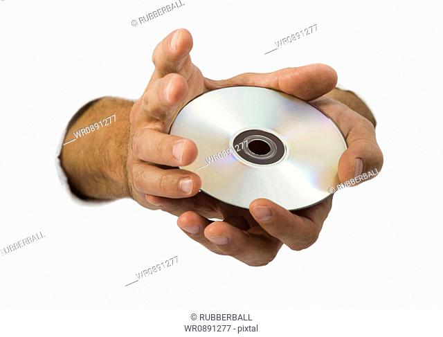 Close-up of a compact disk in a mans hand