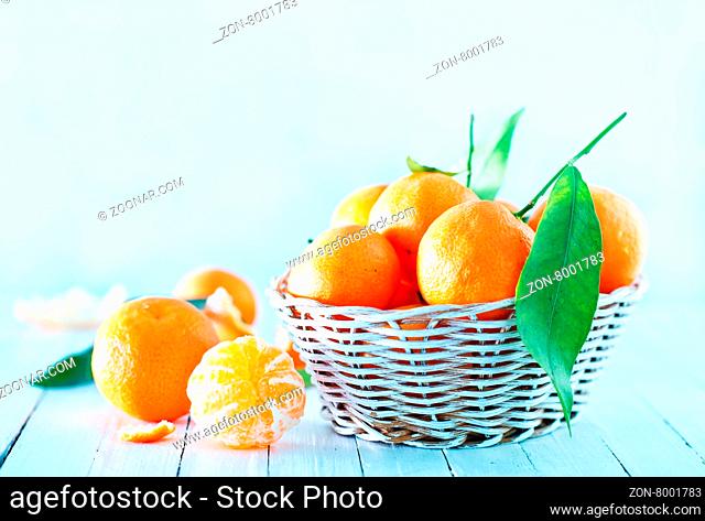 fresh tangerines in basket and on a table