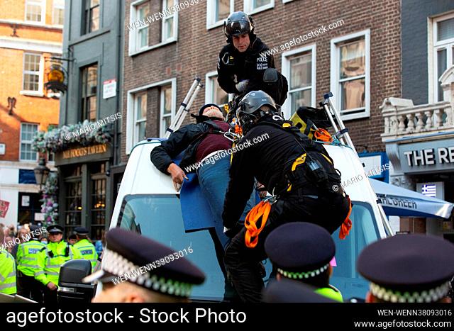 Extinction Rebellion protesters attached themselves to the top of a van. Police team removed them before arrest on the first day of the 'Impossible Rebellion...