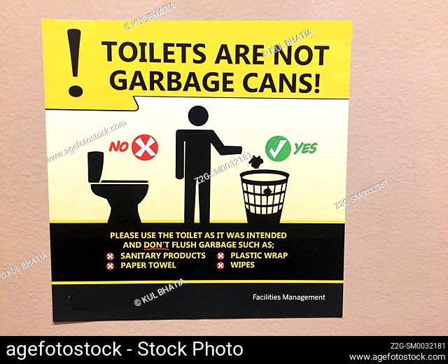 Garbage etiquette. Images and words in a washroom, Ontario, Canada. Simple, direct, universally accessible message