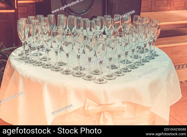 Table with champagne glasses, prepared for celebration, retro toned