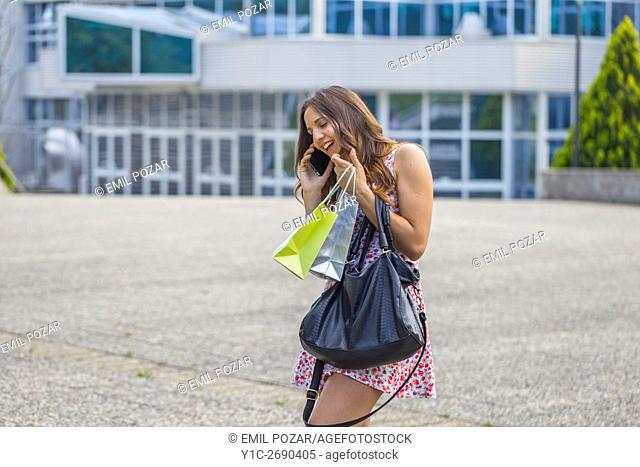 Young woman shopper sudden phone call