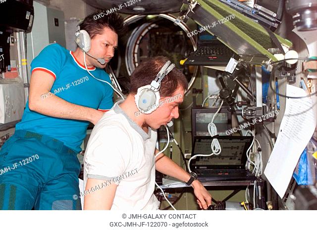 Cosmonauts Sergei Volkov (right) and Oleg Kononenko, Expedition 17 commander and flight engineer, respectively, monitor data at the manual TORU docking system...