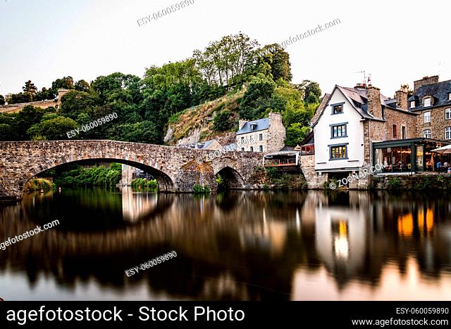 View of the medieval vridge over river Rance and the harbour of the city of Dinan, French Brittany. Long exposure