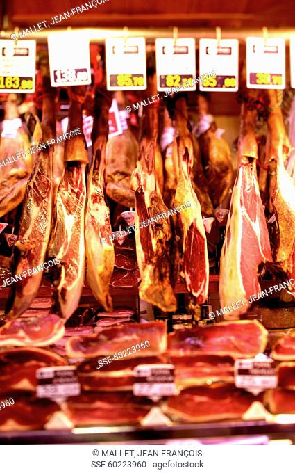 Selling raw ham at the Boqueria market in Barcelona