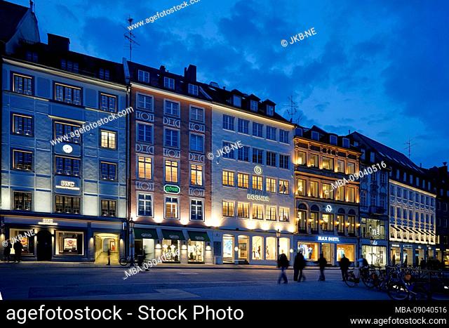 Germany, Bavaria, Munich, residential street, shops, row of houses, in the evening