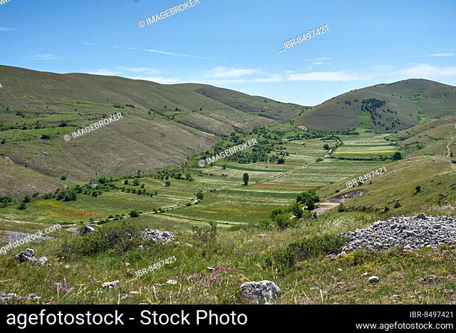 Karst landscape, polje with fields, Gran Sasso mountain landscape, near the mountain village of Santo Stefano di Sessanio