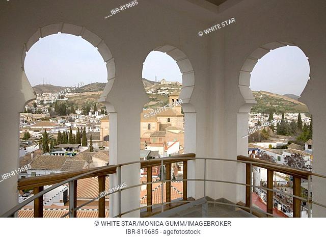 View through the arches of the mosque minaret onto the El Albayzín or Albaicín quarter of Granada, Andalusia, Spain