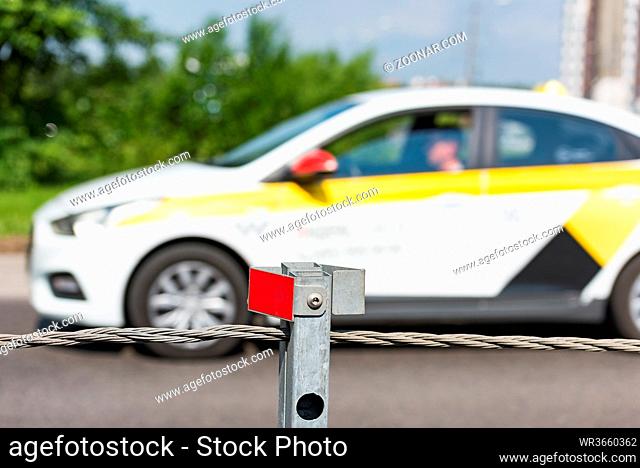 Barrier guard on the road pole with a tensioned cable between the oncoming lanes of the car for safety