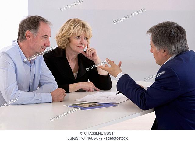Couple meeting with real estate agent