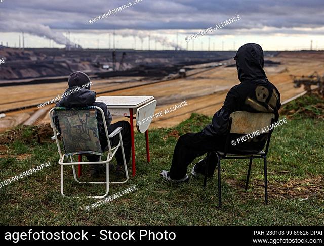 dpatop - 03 January 2023, North Rhine-Westphalia, Lützerath: Activists sit on the edge of the open pit lignite mine. Since Monday