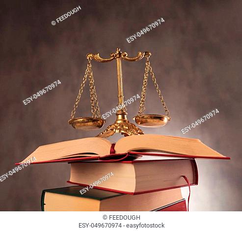 learning to be fair in all decisions. antique scale on top of a pile of books, studying law concept