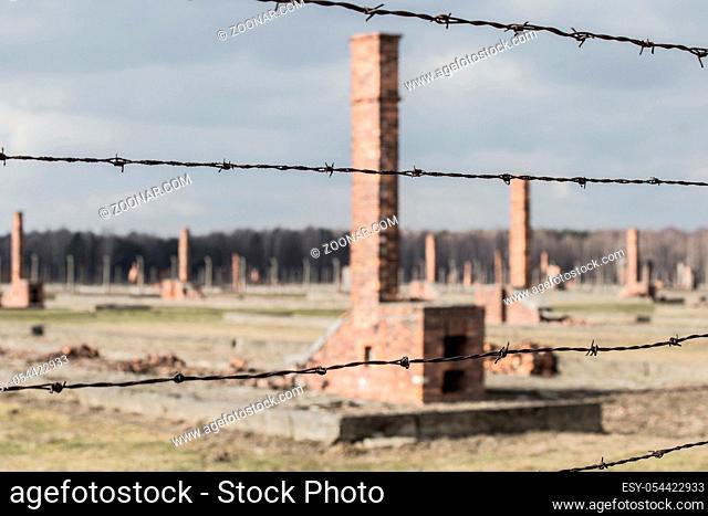 Auschwitz II Birkenau, ruins of barracks at Birkenau. Stoves and chimneys are all that remains of old wooden concentration camp barracks March 12, 2019 war