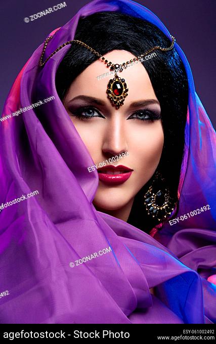 Beautiful young woman with eastern style bright makeup. Beauty shot. Copy space
