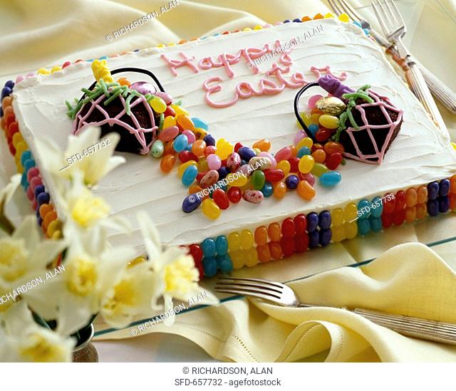 Happy Easter Cake Decorated with Jelly Beans and Easter Candy, On a Platter with Forks