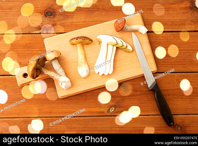 edible mushrooms, kitchen knife and cutting board