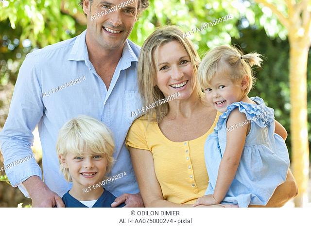 Family together outdoors, portrait