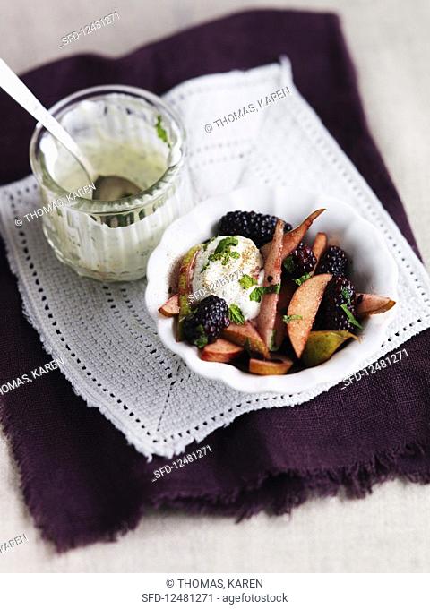 Fruit salad with cream, blackberries, pears and mint
