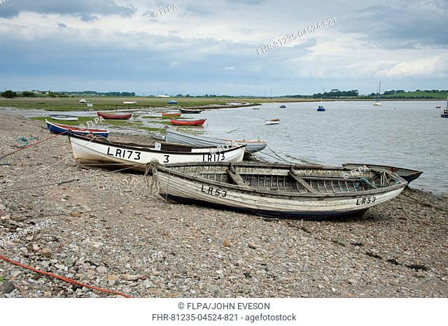 View of boats on shoreline at coastal village, only community on U.K. mainland dependent upon tidal access, with vehicular access to village via single-track...