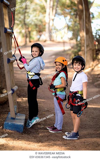 Portrait of happy kids preparing for zip line
