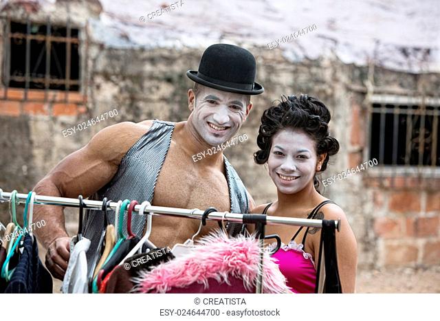 Handsome clown with muscles and hat with partner