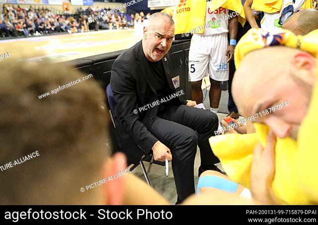 15 January 2020, Mecklenburg-Western Pomerania, Rostock: Dirk Bauermann, the new coach of the Rostock Seawolves, speaks to his team during a time-out at their...