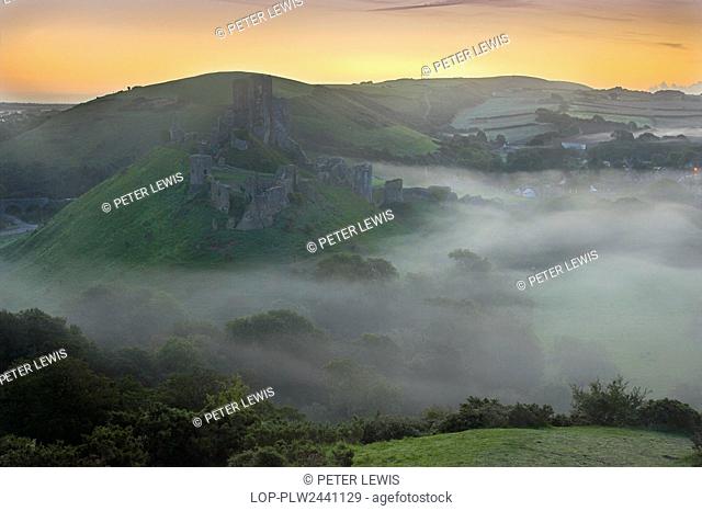 England, Dorset, Corfe Castle. Corfe Castle surrounded by low lying mist at dawn