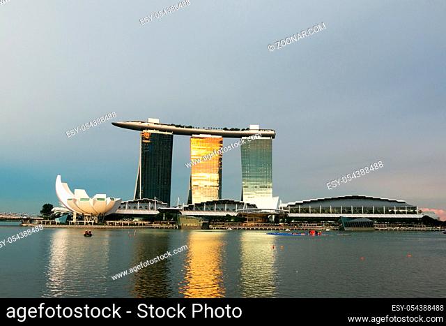 landmark modern building near river in singapore