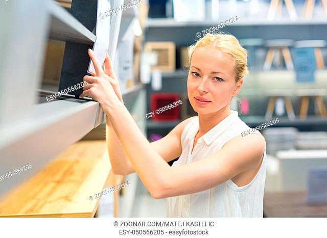 Caucasian woman shopping for furniture, recliner and home decor in store